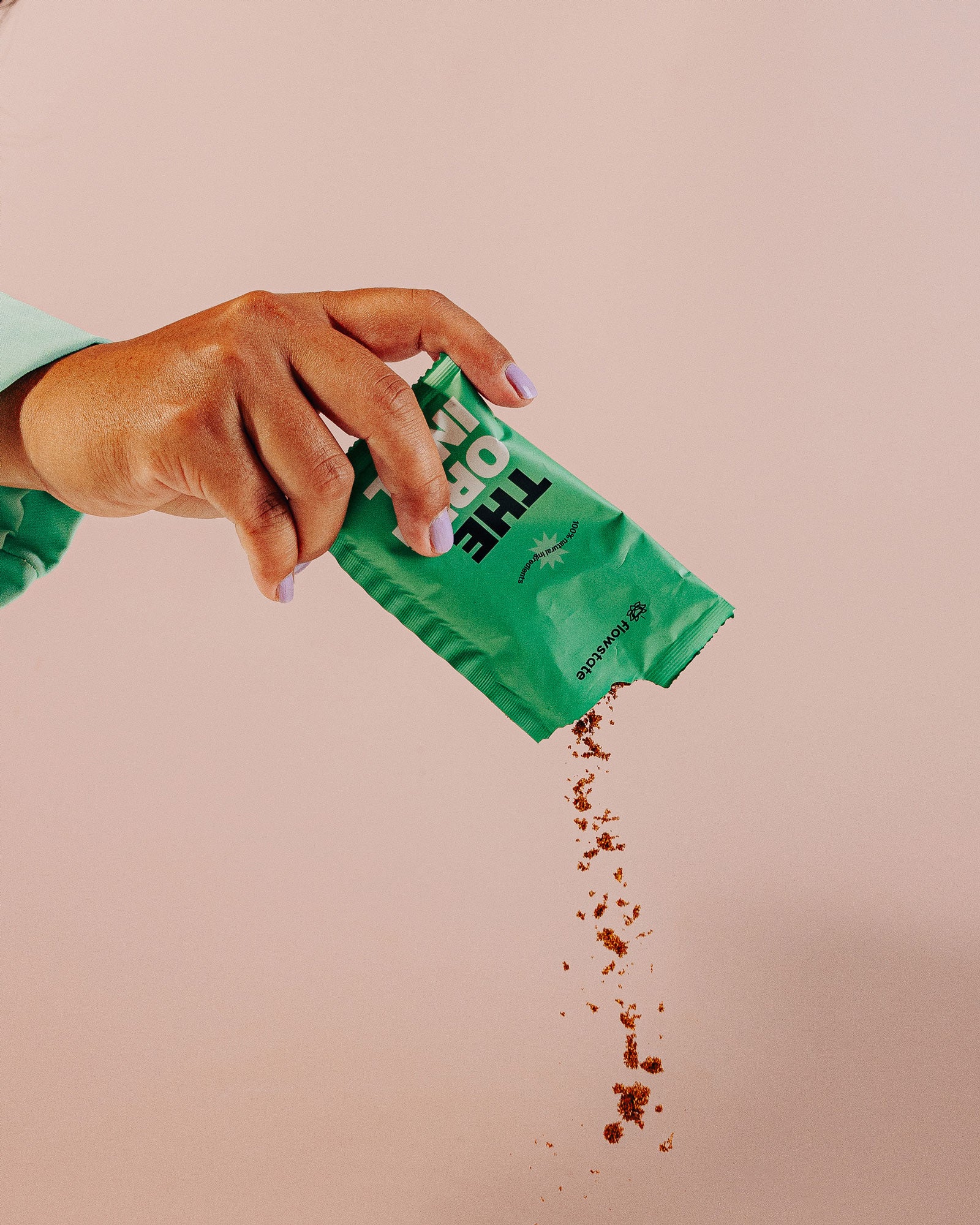 Hand pouring Original Flowstate coffee out of the sachet